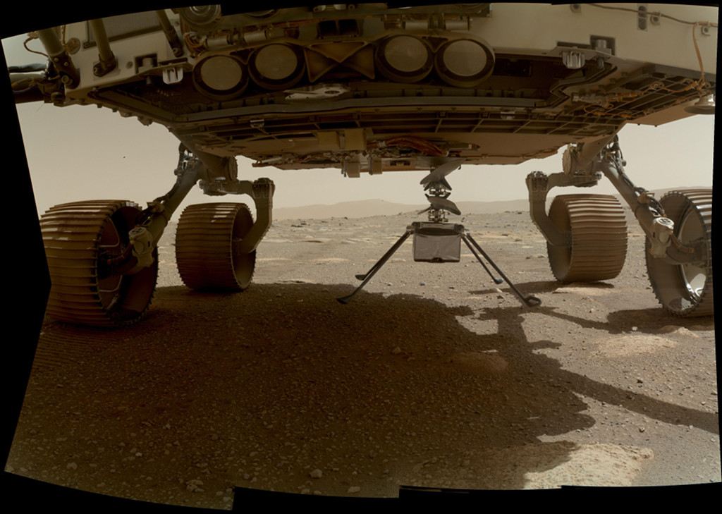 The Ingenuity helicopter beneath the Perseverance rover on Mars. See Explanation.  Clicking on the picture will download the highest resolution version available.