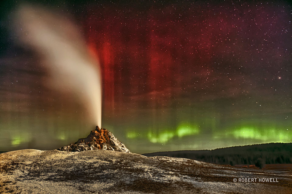 The featured image shows White Dome geyser erupting in Yellowstone
National Park with colorful aurora in the background. 
Please see the explanation for more detailed information.