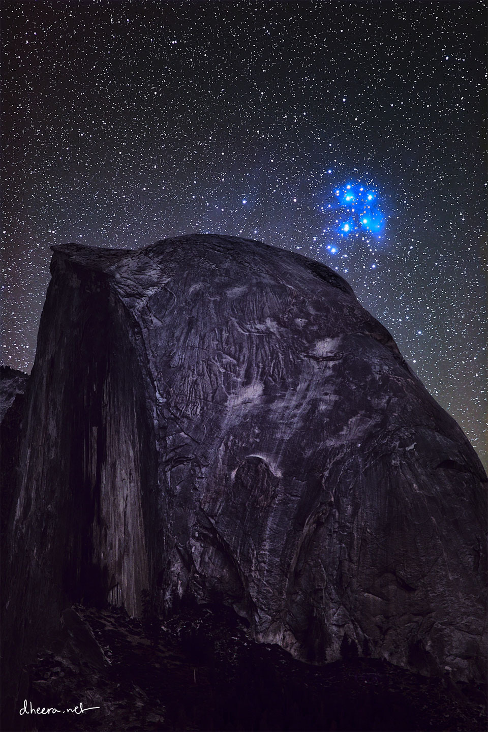 The featured image shows the bright blue Pleiades star cluster
behind Half Dome, a large circular rock formation that appears 
dark but with bright grooves.
Please see the explanation for more detailed information.