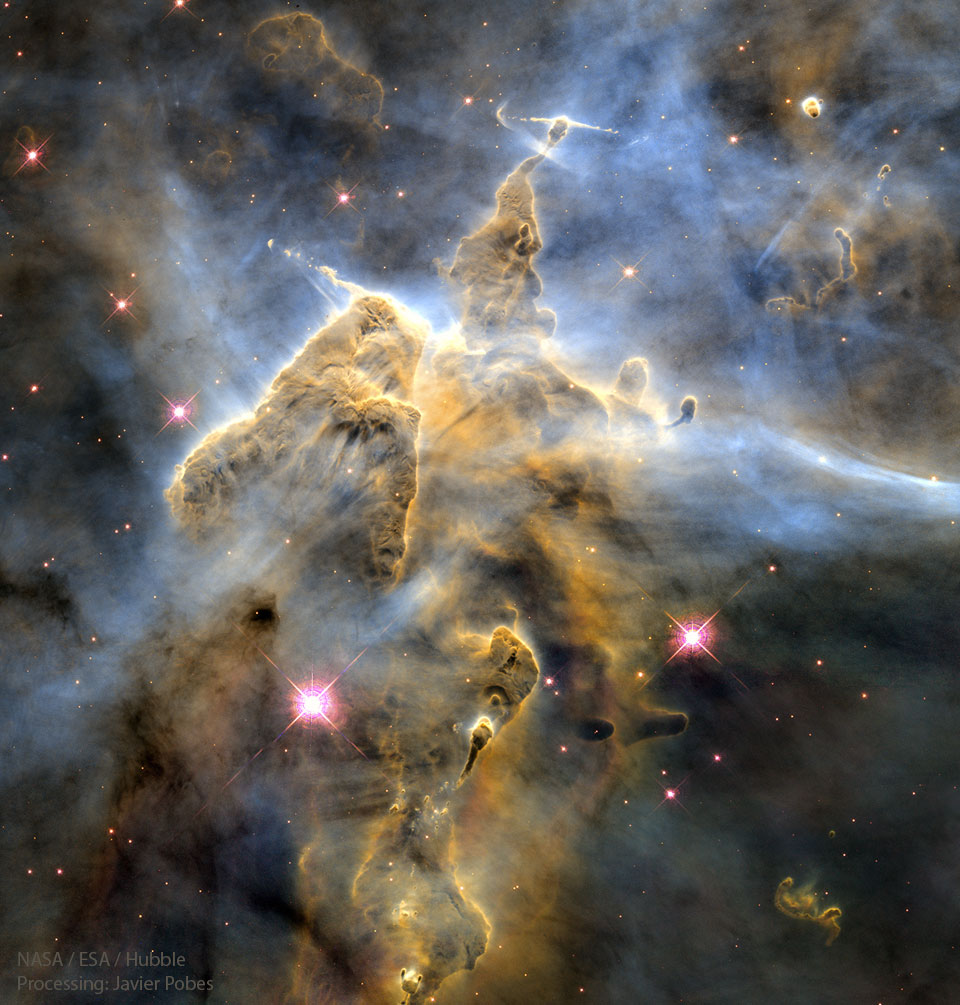The featured image shows a large pillar of dust and
gas in the Carina Nebula. The pillar has many humps and 
several jets.
Please see the explanation for more detailed information.