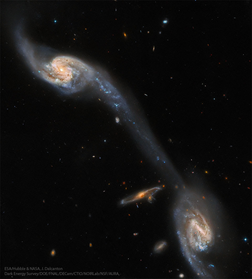 The featured image shows a several interacting
spiral galaxies with a bridge of stars and gas connecting
the two brightest galaxies. 
Please see the explanation for more detailed information.