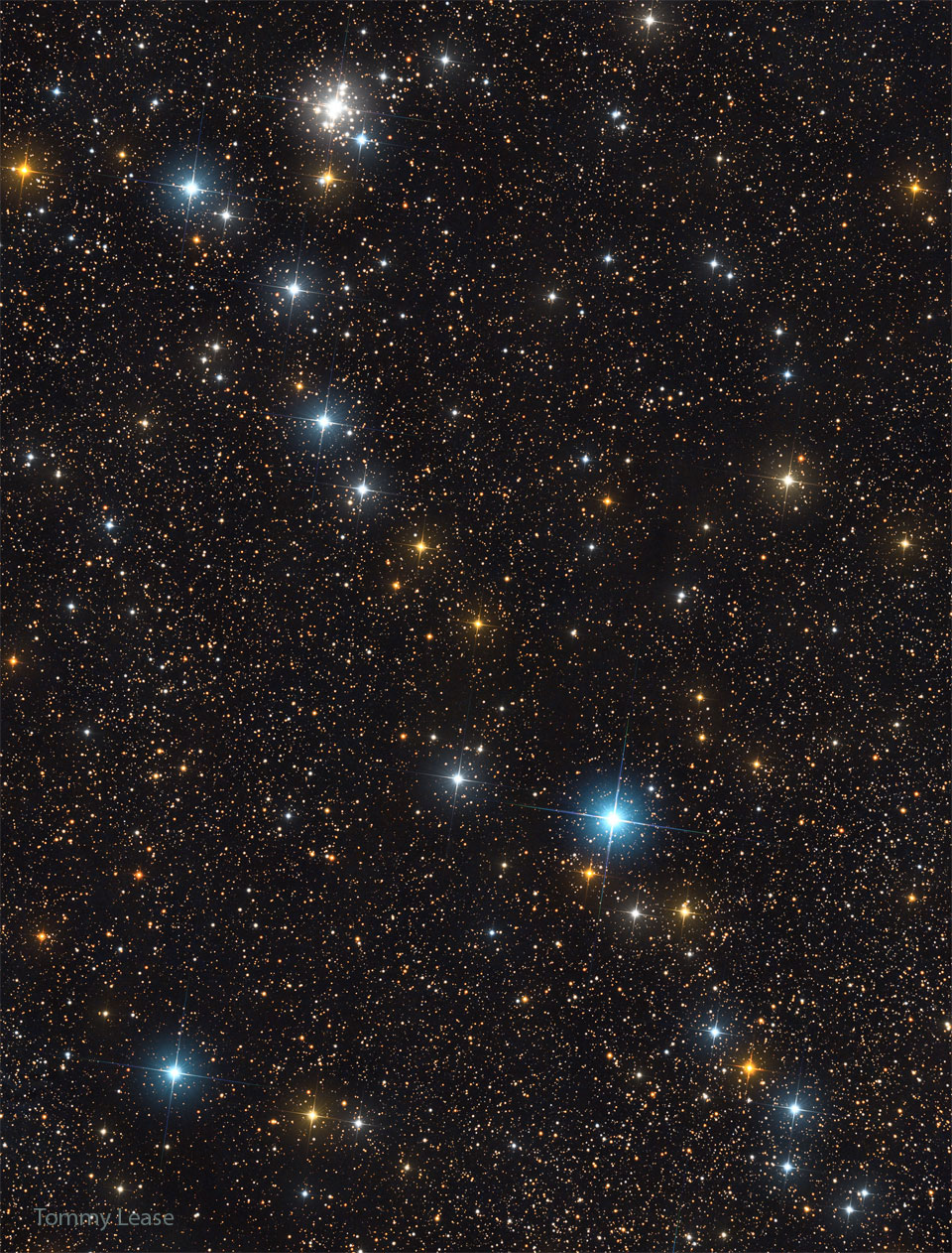 The featured image shows a line of bright stars strewn diagonally
across a starfield of more dim stars. A cluster of stars is also visible
near the top left of the image. 
Please see the explanation for more detailed information.
