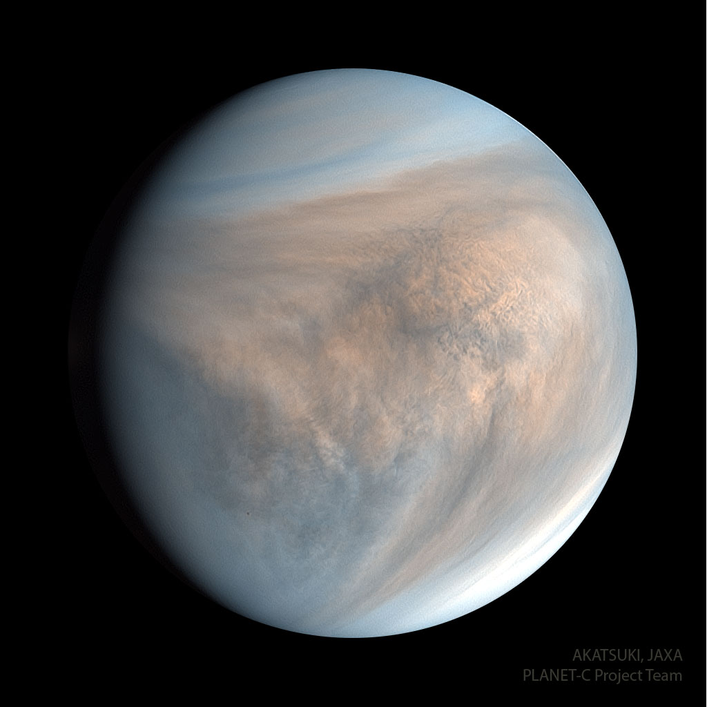 Planet Venus is pictured in ultraviolet light. The 
spherical planet appears circular in tan colors with hints
of blue. Complex cloud patterns are evident. 
Please see the explanation for more detailed information.