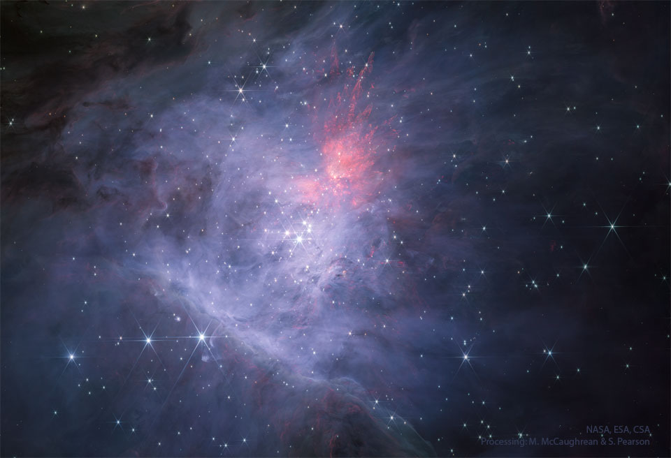 The center of the Orion Nebula is seen in infrared light
as imaged by the James Webb Space Telescope. In the center is
the Trapezium Star Cluster. The main image is in near infrared
light, while the rollover image is in mid-infrared light.
Please see the explanation for more detailed information.
