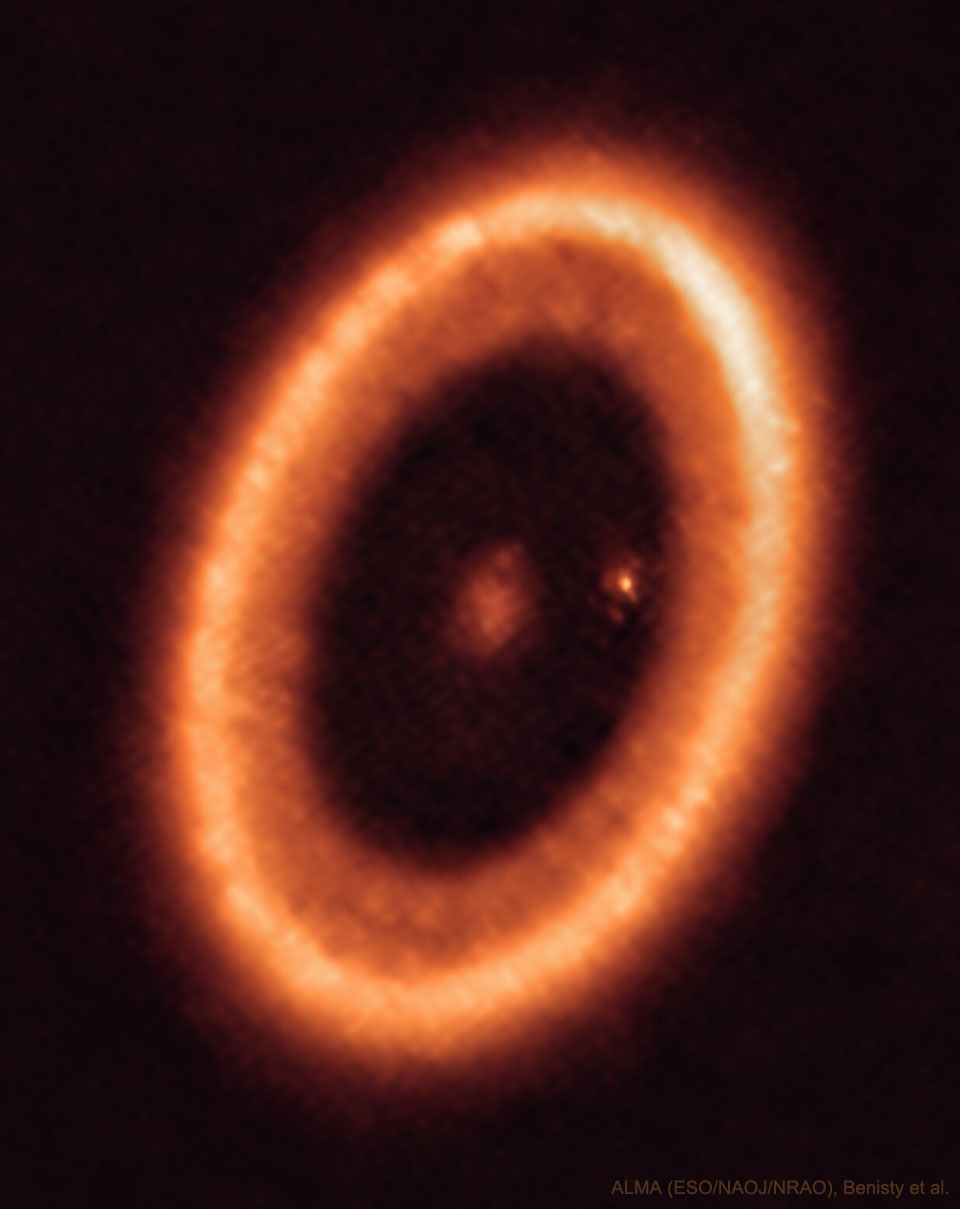 An orange elliptical ring is shown that is a disk of
gas and dust around the star PDS 70. In the center of the disk
is a fuzzy spot and near the inner right edge of the disk is
another fuzzy spot. 
Please see the explanation for more detailed information.