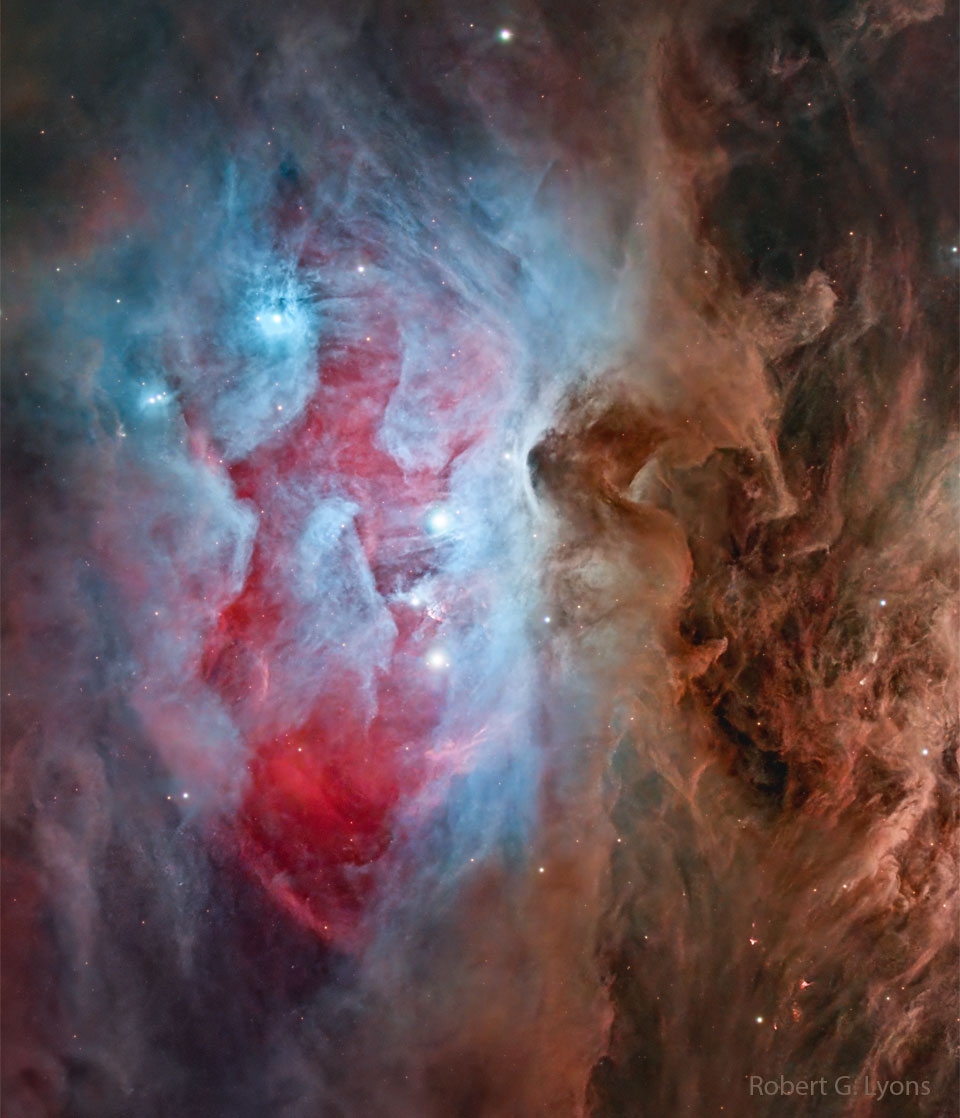 A complex nebula is shown that is mostly blue
and red on the left half and mostly brown on the right. 
Several bright stars are visible, and many filaments
run through, in particular on brown dust filamnents
on the image right. 
Please see the explanation for more detailed information.