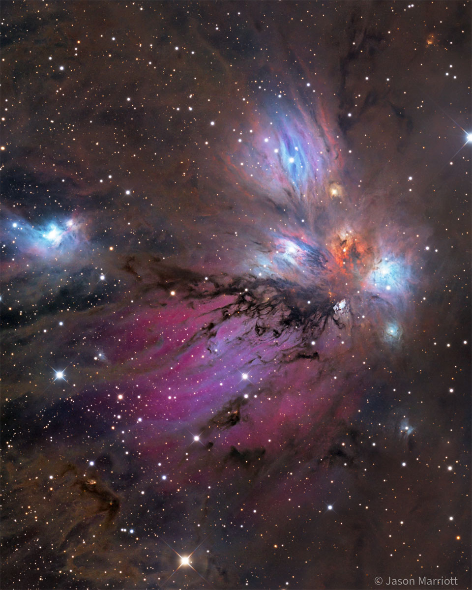 A starfield surrounds a colorful nebula that
glows both red and blue but is filled with dust, both 
light brown and dark brown. 
Please see the explanation for more detailed information.