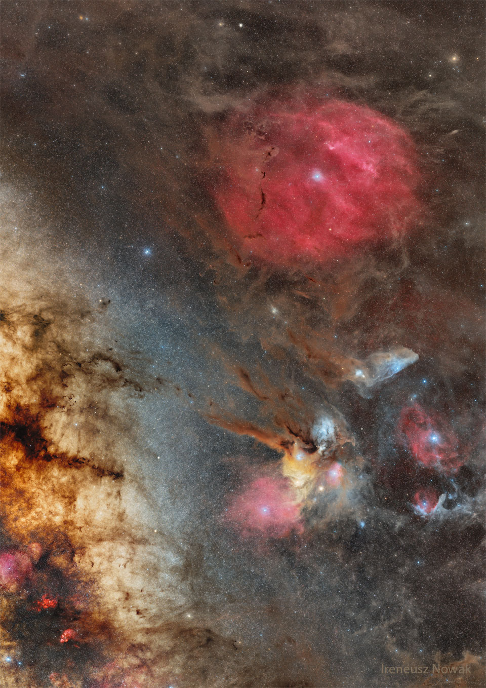 A very colorful sky field is shown featuring many stars and
nebulas that appear red, yellow, blue, and brown. 
Please see the explanation for more detailed information.