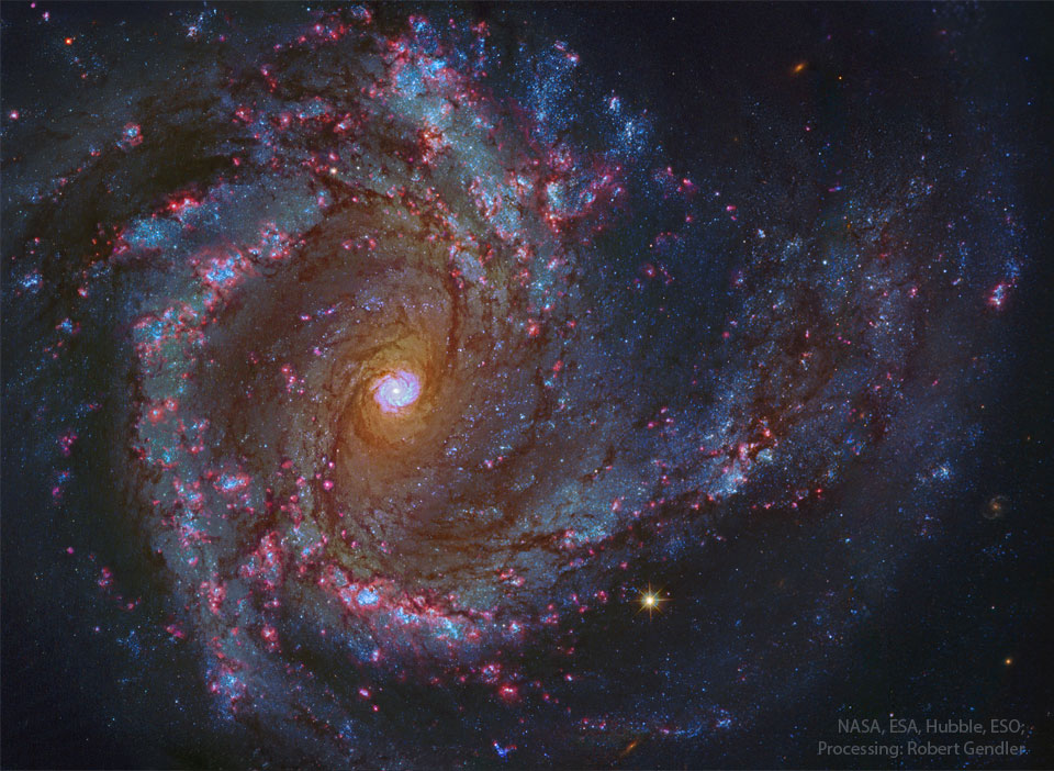 A sprawling spiral galaxy is shown in great detail.
This galaxy has blue spiral arms and a bright center
that itself seems to look like a spiral galaxy.
Please see the explanation for more detailed information.