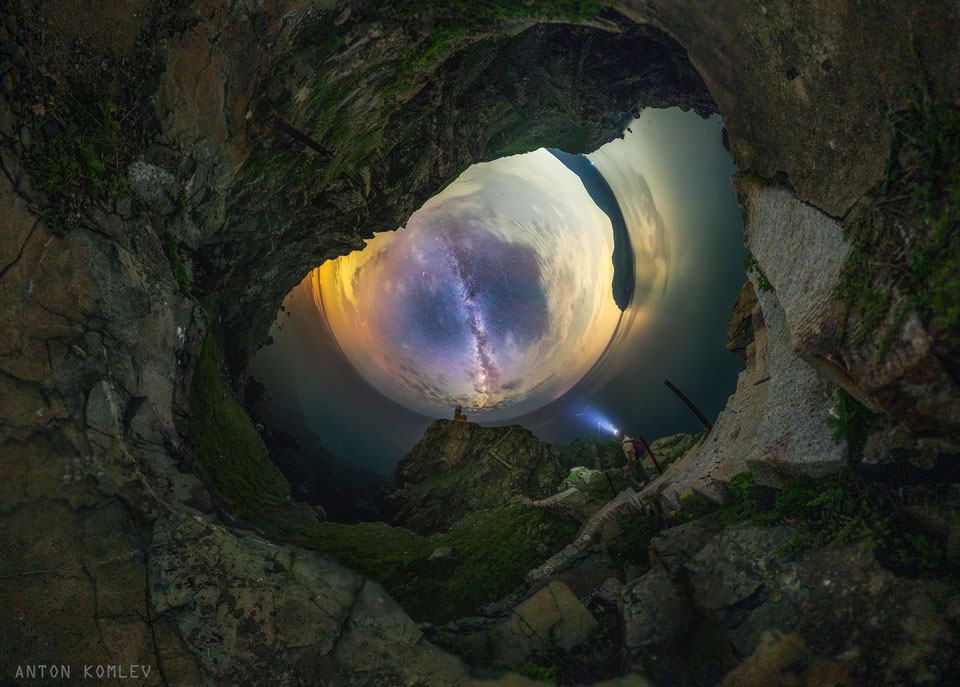 A fisheye image of the sky is shown on the left
with the landscape-foreground surrounding it. The plane of
our Milky Way Galaxy runs down the center. At first glance
the sky looks like oddly like an eye of a dragon. 
Please see the explanation for more detailed information.