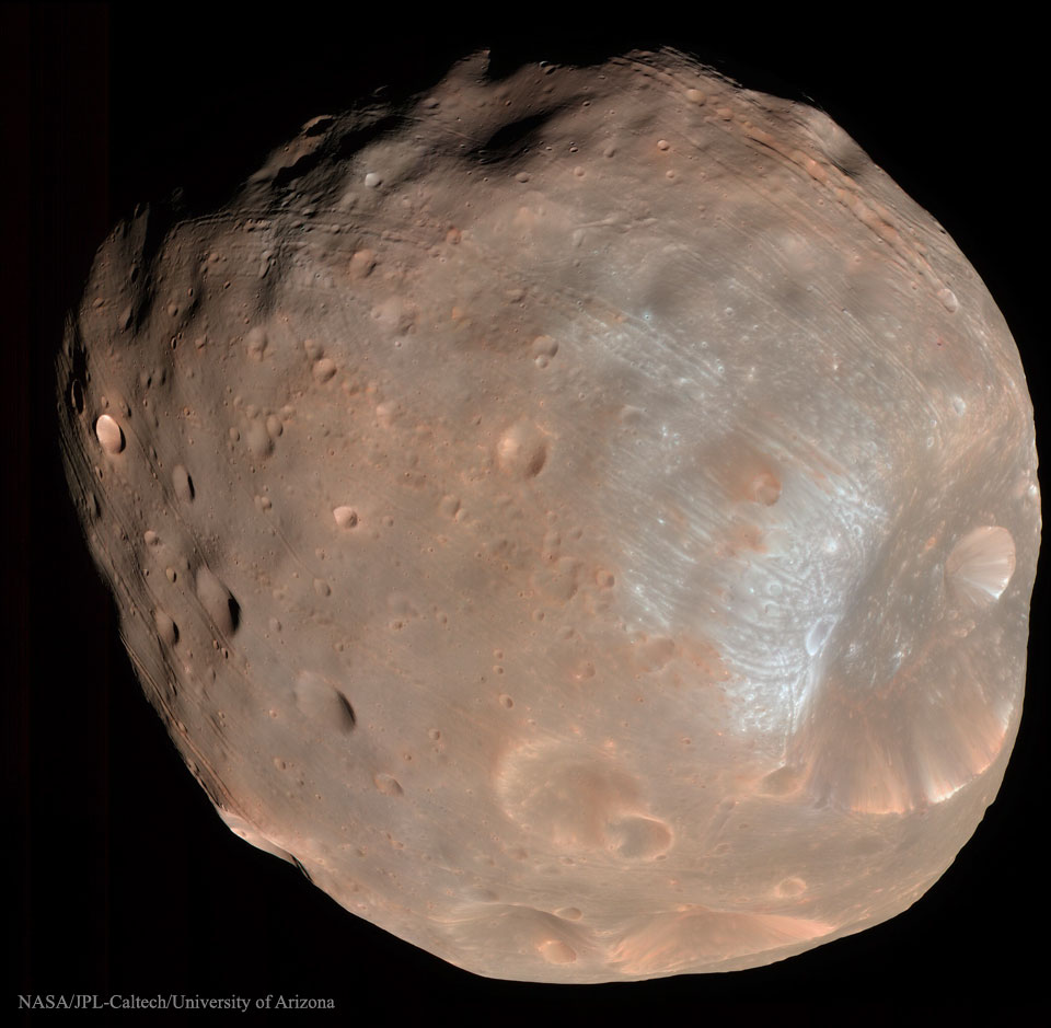 A large irregularly shaped object is shown that is mostly 
brown and shows many craters. 
Please see the explanation for more detailed information.