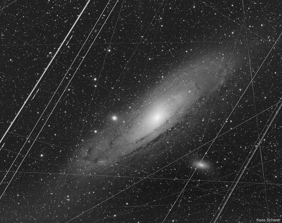 A spiral galaxy is pictured that takes up much of the
frame. Many straight lines run through it. In the alternative
image, the straight lines have been removed.
Please see the explanation for more detailed information.