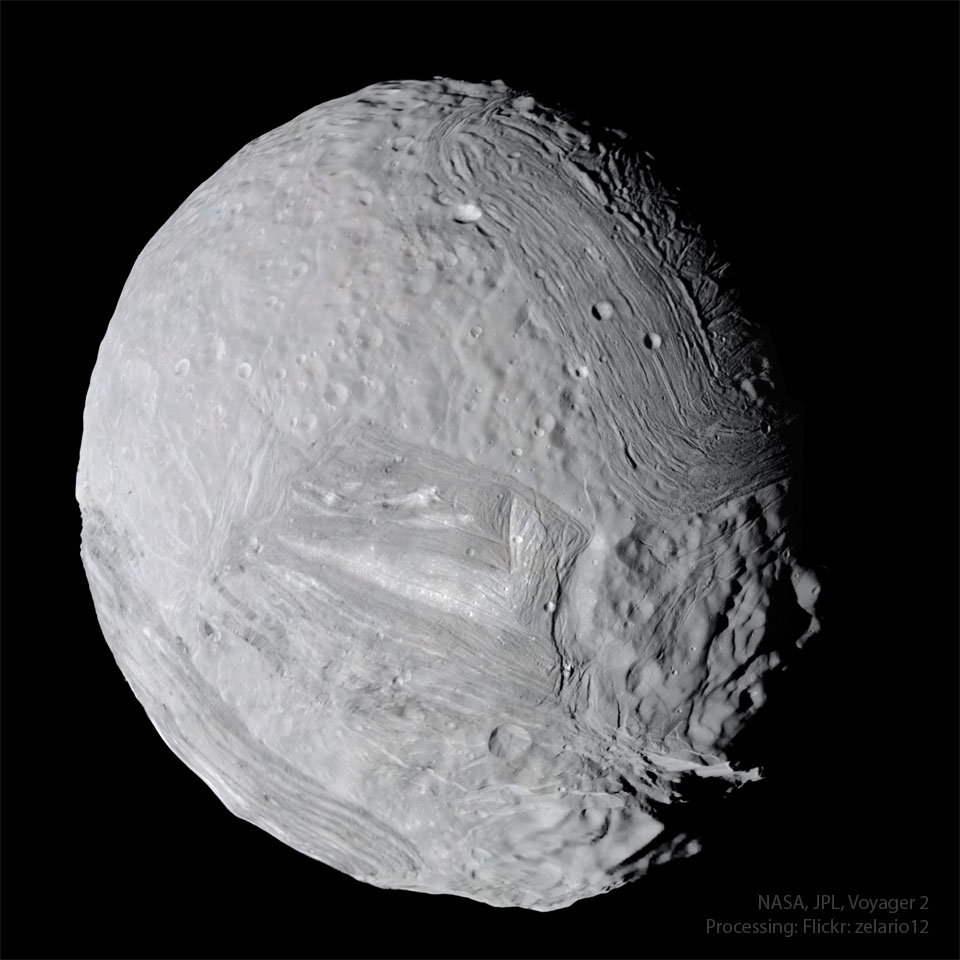An unusual gray body looks like a more jaggged 
version of the Earth's moon, but close up. Craters 
and stripes run across much of the surface. 
Please see the explanation for more detailed information.
