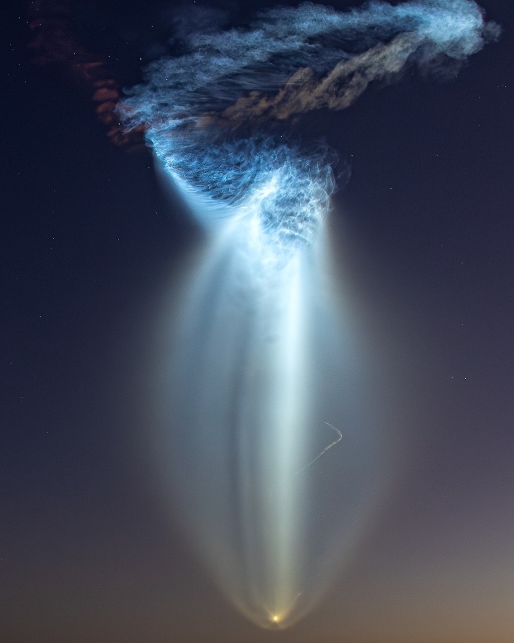 A SpaceX Falcon 9 rocket launch produces a glowing cloud,
	  reminiscent of a jellyfish.
	  Please see the explanation for more detailed information.